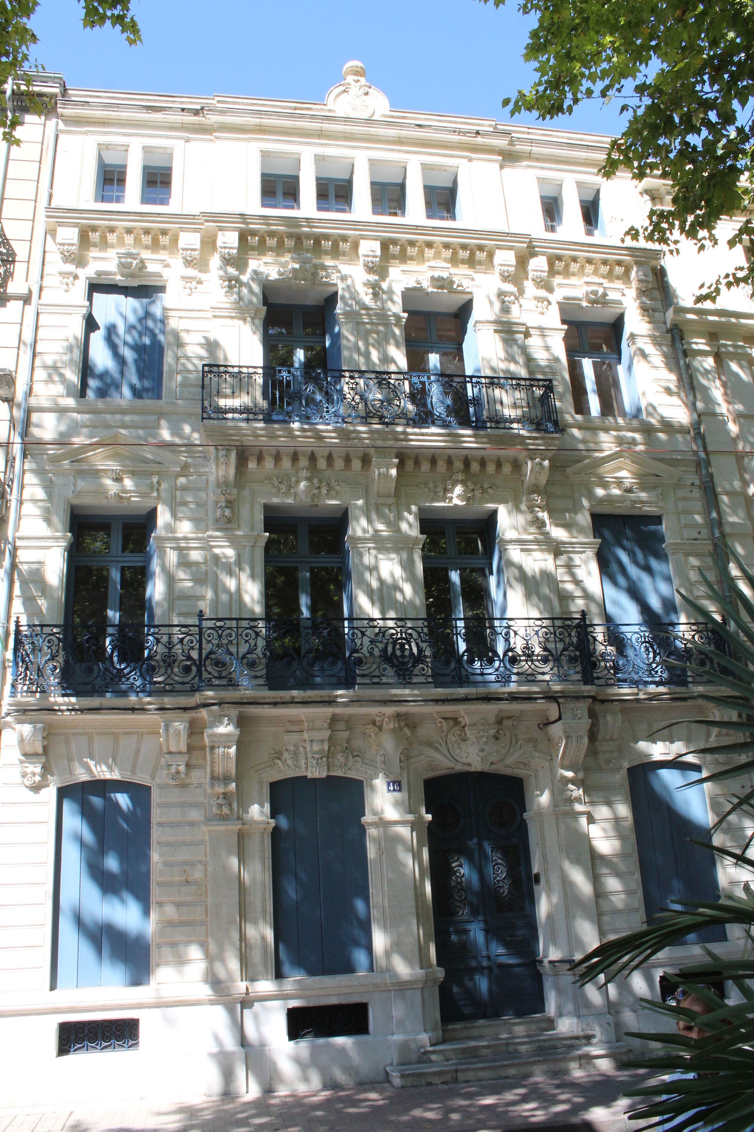 A multi-story building with ornate architectural details, including columns and decorative moldings.