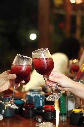 Two people toasting with wine glasses filled with a red beverage. - Villa Lu Amazon Lodge (Tarapoto)