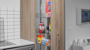 A kitchen with a white countertop, a metal rack with cereal boxes, and a white cabinet with a small mirror. - 3BR Home Near Werribee Plaza w/ Free Parking + Free Wifi (Mambourin)