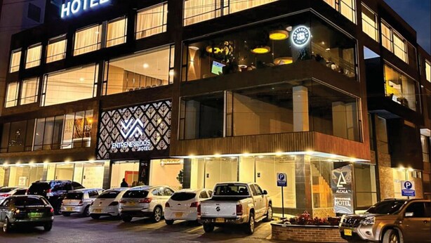 A hotel with a modern design, multiple floors, and a prominent sign. - Entrenevados Hotel (Ipiales)