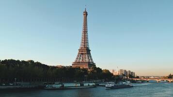 The Eiffel Tower with a river and bridges in the foreground.