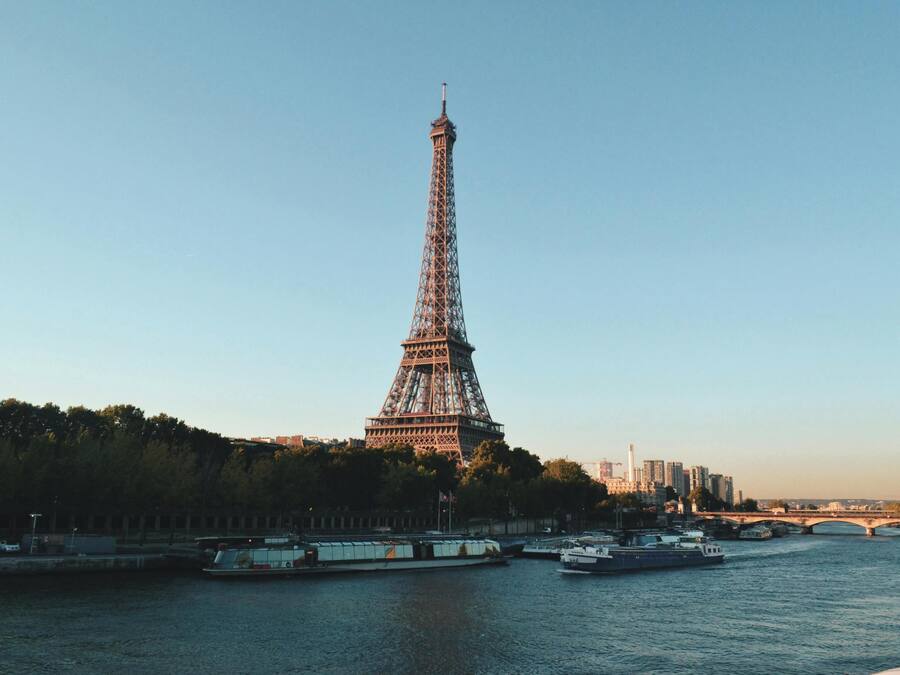 The Eiffel Tower with a river and bridges in the foreground.
