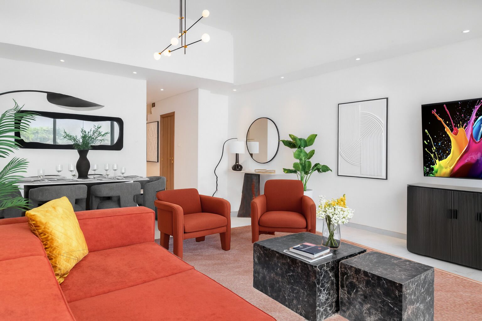 A modern living room with a red sofa, orange armchairs, a marble coffee table, and a dining area with a white table and chairs.