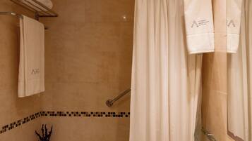 A bathroom with a bathtub, a sink, a toilet, and a shower curtain.