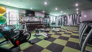 A gym with exercise equipment, weight machines, and a checkered floor. - The George, 3BR Home by Velvet Ditch Villas (Oxford)