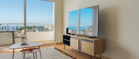 Apartamento conforto, vista para a cidade | Área de estar