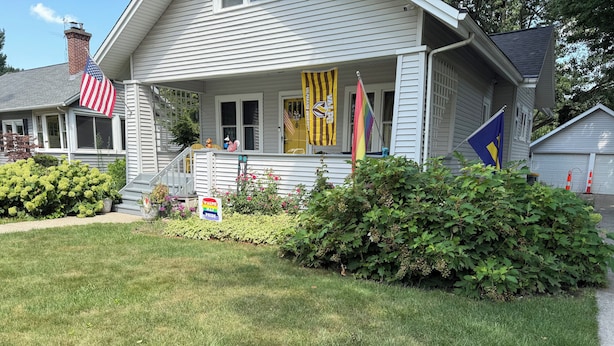 Et hus med en veranda, amerikansk flag og regnbueflag, samt et skilt der siger "VALPO PRIDE".