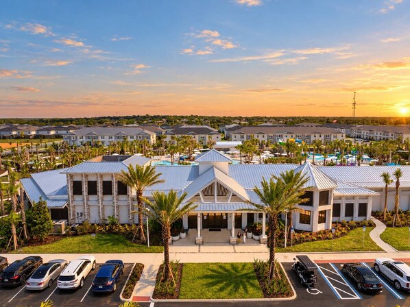 A resort with multiple buildings, a swimming pool, and a parking lot.