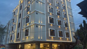 A multi-story building with a modern design, featuring a series of balconies and large windows. - Carry Plus Hotel (Indore)