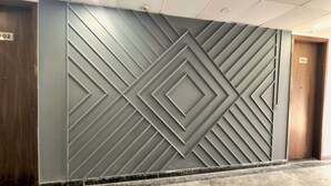 A wall with a geometric pattern and a door labeled "102". - Hotel HomeAste 001 Near Yashobhoomi Convention Center (New Delhi)