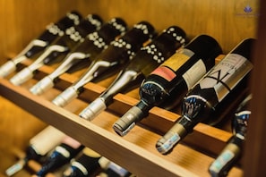 A wooden wine rack with multiple bottles of wine.