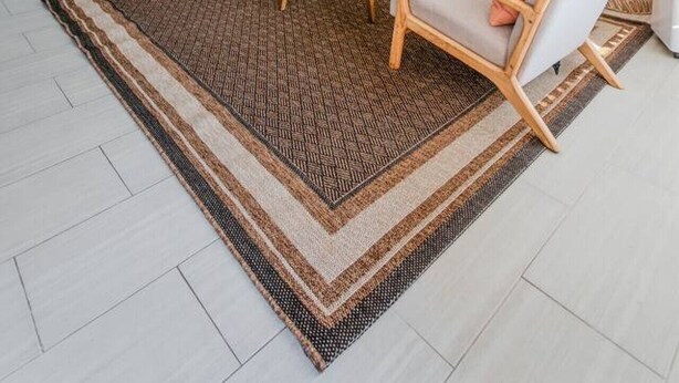 A living room with a ceiling fan, a sofa, two armchairs, a coffee table, and a rug. - Spacious 2BR | Patio + Sleeps 6 | Steps to Beach (Oceanside)