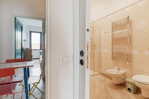 A bathroom with a shower, sink, and toilet.
