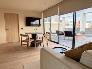 Luxury Apartment, Terrace, City View | Living area | 55-inch flat-screen TV with cable channels