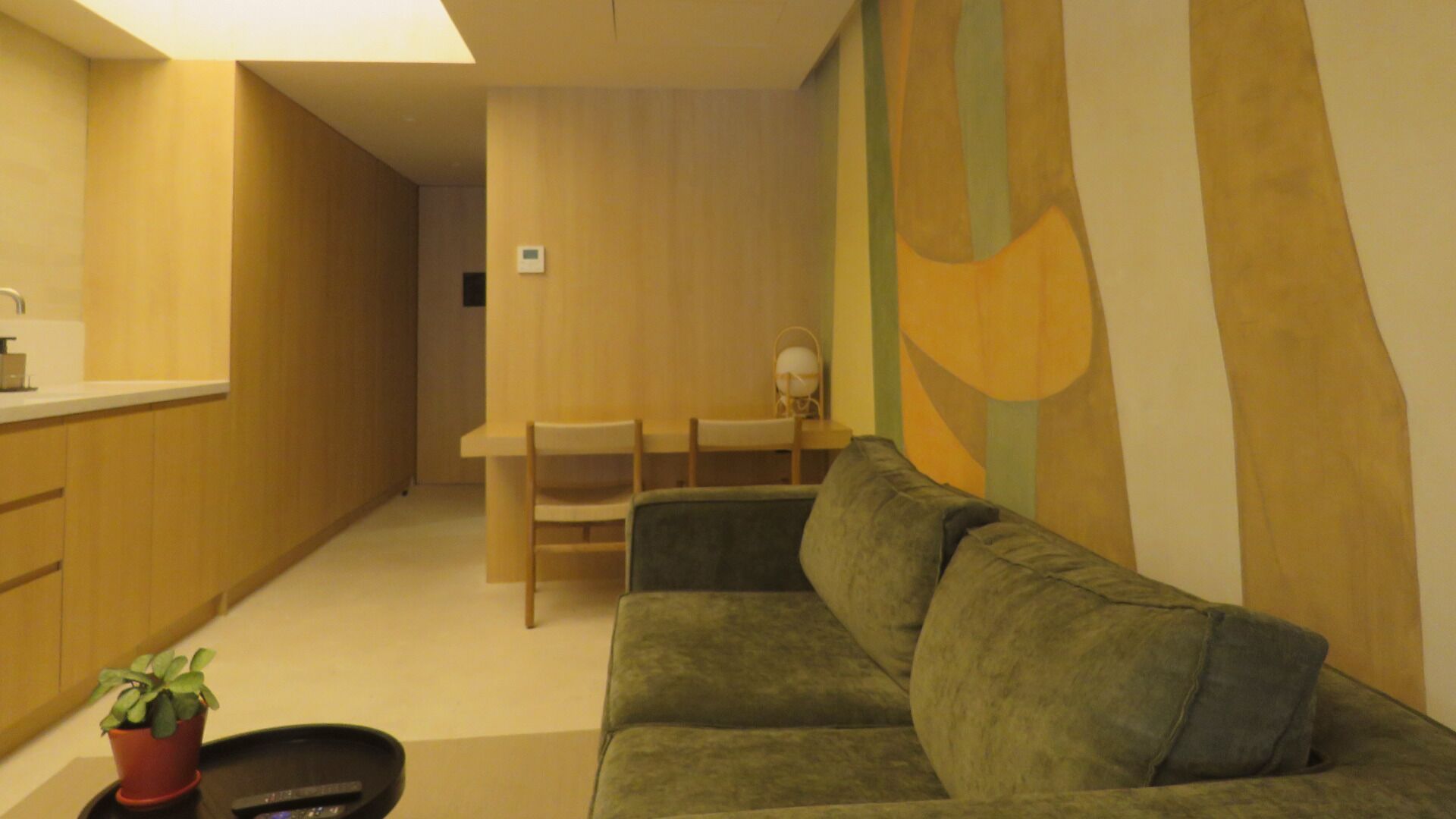 A compact living space with a sofa, a small table, and a chair.