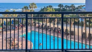 A pool area with lounge chairs and a view of the ocean. - Shell Yeah! Oceanfront, Indoor Pool (Myrtle Beach)
