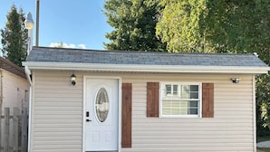 A single-story building with a white door, a small window with shutters, and a chimney. - 4 Blocks to the Erie Beaches (Millcreek Township)