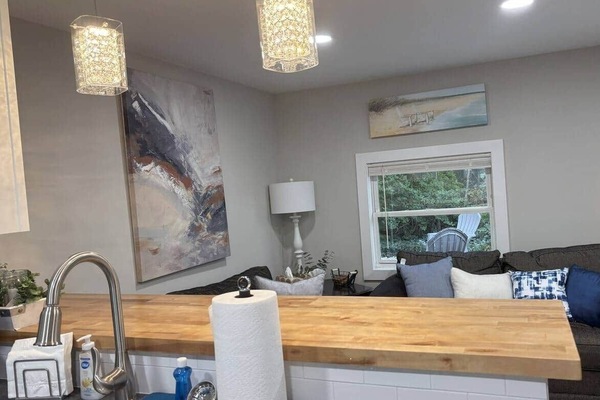 The kitchen flows into the living room area. It is fully stocked with everything that you need to prepare a meal.