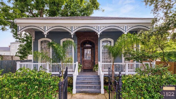 A historic house with a central entrance, white railings, and a number plaque. - Victorian Villa w Heated Pool & Hot Tub 5BR|6BA (New Orleans)