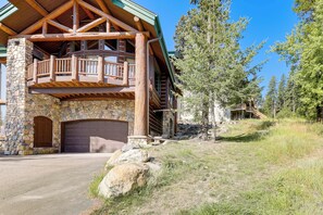 A stone and wood lodge with a stone entrance, a large garage, and a balcony with wooden railings. - Ski-In/Out, Hot Tub: Spacious Retreat in Whitefish (Whitefish)