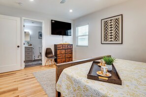 A bedroom with a bed, a dresser, a TV, and a window. - 4 Mi to SoFi Stadium: Modern Home w/ Fenced Yard (Los Angeles)