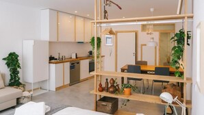 A modern apartment with a kitchen, dining area, and a living space.