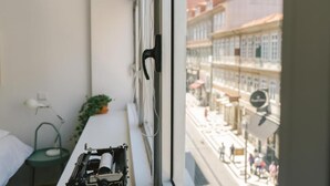 A room with a window overlooking a street.