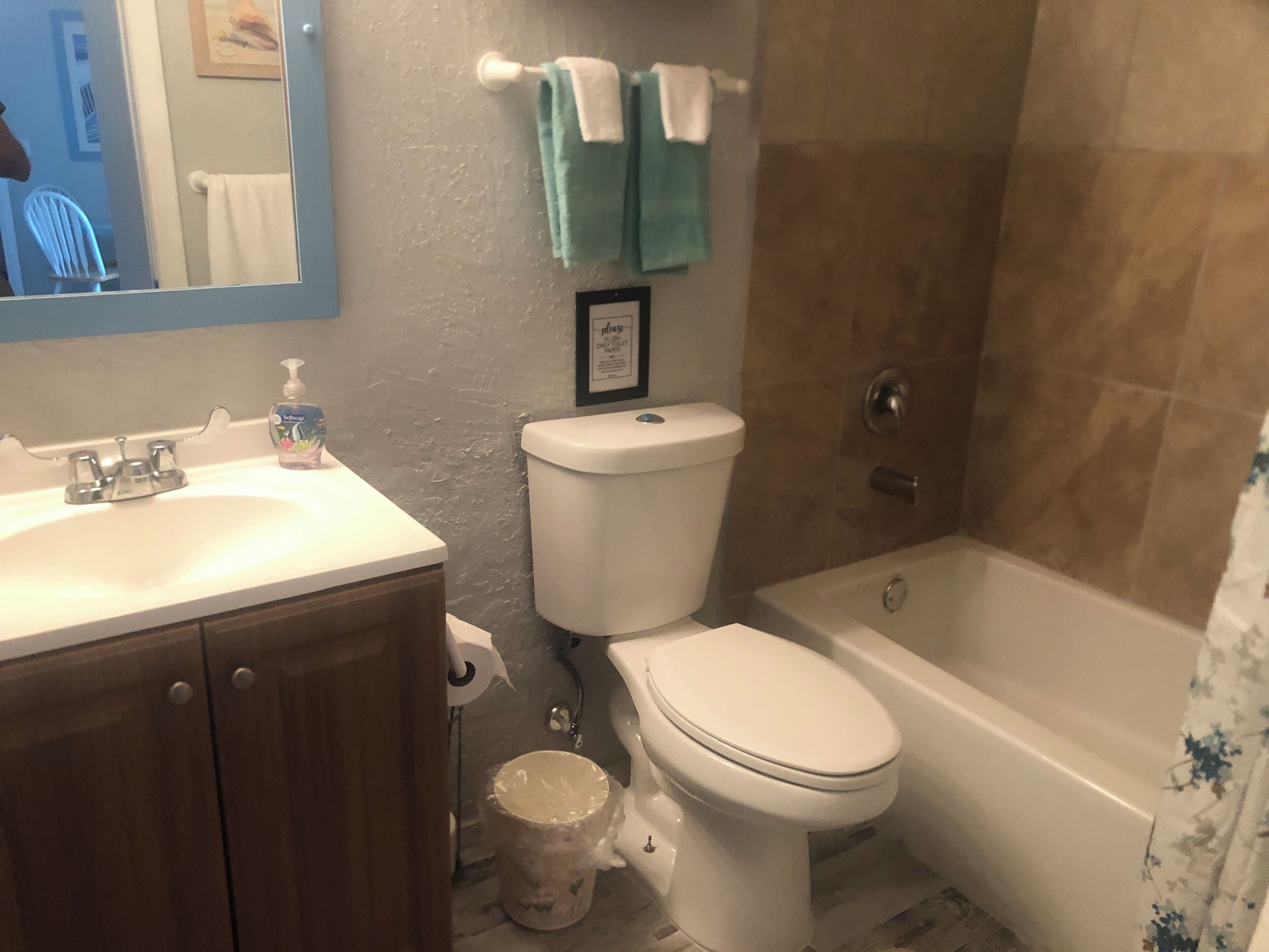 A bathroom with a sink, toilet, and bathtub.