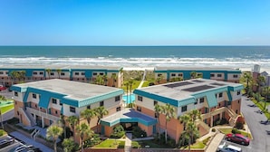 A beachfront hotel with a pool, multiple floors, and a view of the ocean. - Coastal Oasis Refined Living Ocean Views (St. Augustine)