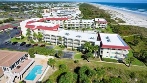 A resort with multiple buildings, a swimming pool, and a beach view. - Oceanfront 3BR Condo: Gated, Breathtaking View (St. Augustine)