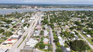 An aerial view of a residential area with streets, houses, and a waterfront.