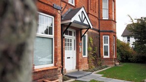 A brick house with a white door, a small front garden, and a number '5' sign. - Boho Flat, Sleeps 8, Near Beach Ideal For Groups (Bournemouth)