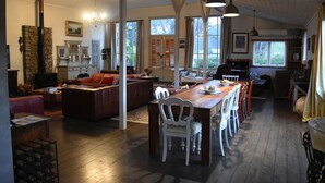 A spacious living area with a fireplace, dining table, and comfortable seating.