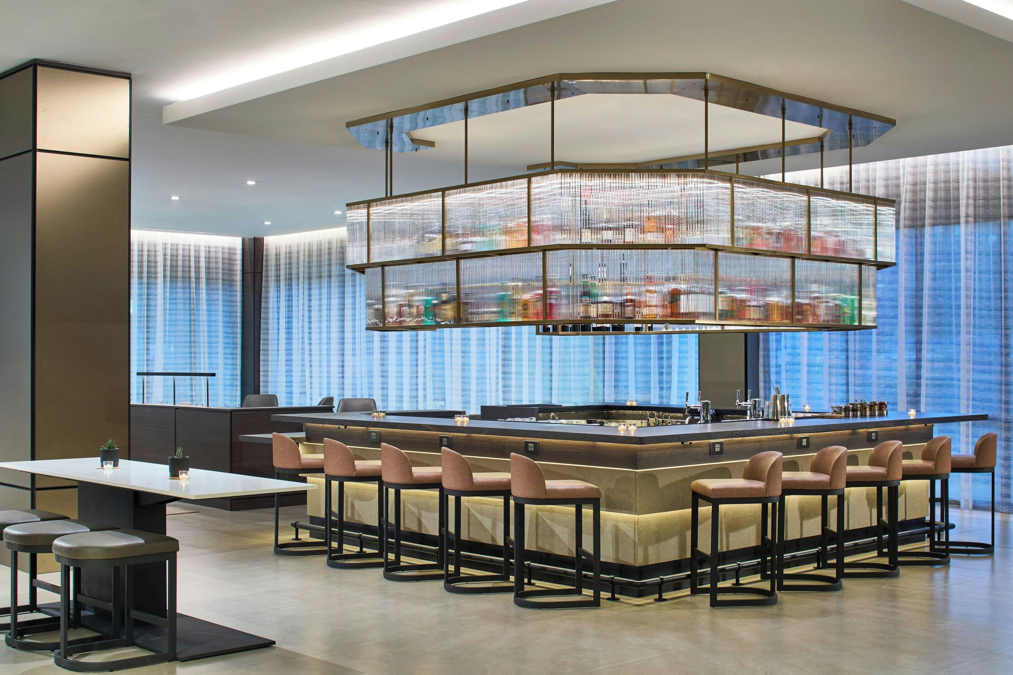 A modern bar area with a central island and seating.