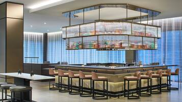 A modern bar area with a central island and seating.