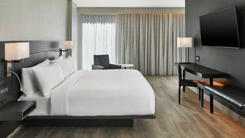 Premium bedding, desk, laptop workspace, blackout drapes