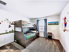 A bunk bed with a ladder, a window with curtains, and wall decals. - Luxury Pool Home Near Disney Resort Access (Kissimmee)