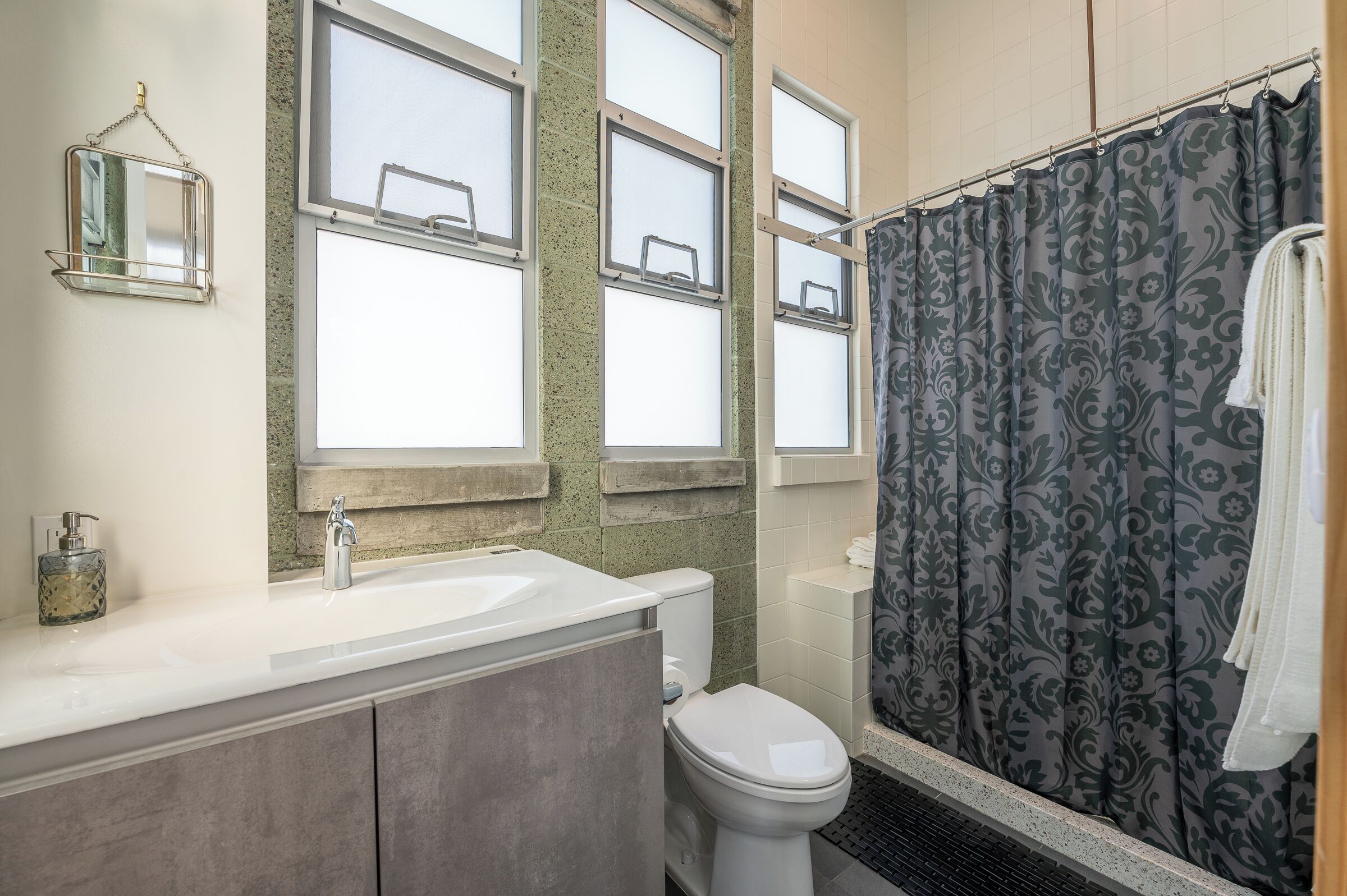 Ein Badezimmer mit Waschbecken, Toilette und Duschvorhang.