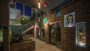 Un intérieur moderne agrémenté d’un escalier, de portes vitrées et d’un éclairage décoratif.