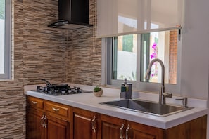 Full-size fridge, microwave, stovetop, cookware/dishes/utensils