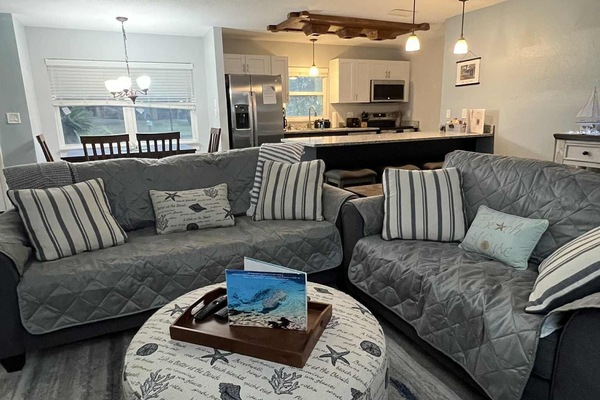 Living Room featuring a couch, love seat and ottoman.