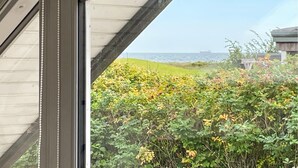 A view through a window with a view of a grassy area and a body of water in the distance. - Awesome home in Tranekær with WiFi (Tranekær)