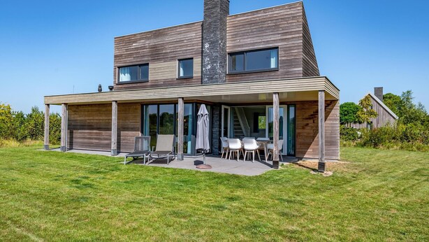 A modern two-story house with a covered patio area. - 3 bedroom amazing home in Kamperland (Kamperland)
