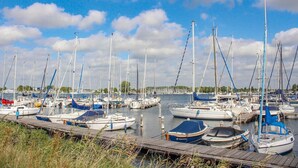 A marina with numerous sailboats docked at wooden piers. - 3 bedroom amazing home in Kamperland (Kamperland)
