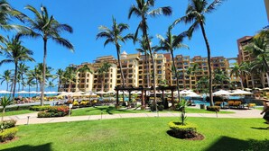 A resort with multiple swimming pools, palm trees, and a large building with balconies. -  2 Bedroom condo in Villa la Estancia in Nuevo Nayarit (Nuevo Nayarit)