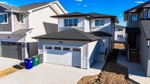 A residential neighborhood with houses featuring attached garages and driveways. - New Modern & Luxury 3BR+2.5 Bath w/Garage Home in Saskatoon, SK (Saskatoon)