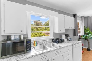 House, Multiple Beds, Patio, Garden View (Broadmoor Bungalow - Both Units) | Private kitchen | Coffee/tea maker