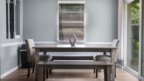 Een eetgedeelte met een lange tafel, banken en stoelen.