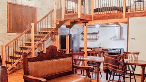 Un intérieur en bois avec un escalier, des meubles en bois et un coin cuisine.