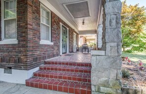 A brick house with a porch, steps, and a stone column. - Snowden Hideaway (Memphis)